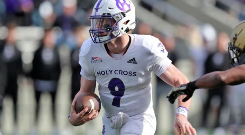 Matthew Sluka, quarterback for Holy Cross, running with the football during a game